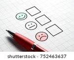 Customer satisfaction survey and questionnaire concept. Giving feedback with multiple choice form. Pen, paper and emotion smiley face icons.