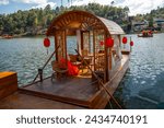 Small photo of beautiful lake There are traditional Chinese boats waiting to transport tourists. At Baan Rak Thai Beautiful village in Mae Hong Son Province, Thailand.