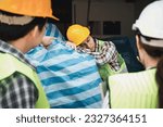 Small photo of Foreman user radio to nurse for first aid Construction worker faint in construction site because Heat Stroke. Worker with safety helmet take a nap because so are tired from working in the hot sun