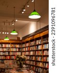 Small photo of London UK. 21 November 2023. Interior of Daunt Books, Holland Park Avenue, west London UK, with green industrial pendant lights hanging from the ceiling.
