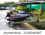 Small photo of Samut Sakhon, Thailand - March 2, 2022 Jet skis are brought up to be cleaned for storage in the dock.