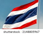 A Large Thai Flag Flutters In...
