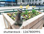 Small photo of Milwaukee, Wisconsin - May 26th, 2018: The Gertie the Duck bronze statue and her six ducklings near the Wisconsin Avenue bridge created by Gwendolyn Gillen intriguing visitors as they pass by.