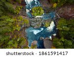 Incredible look down travel aerial photograph of Saxon Falls waterfall, cascades and whitewater rapids meandering through the rocks on the Montreal River on the border between Wisconsin and Michigan.