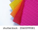 Small photo of Bright Color palette of special textile mesh. Polyester mesh with foam rubber for the manufacture of backpacks. Lining mesh with foam for the inside of a bag or clothes.