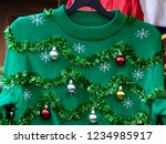 Beautiful or ugly: green Christmas sweater with decor balls 
