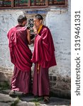 Small photo of ZHANANG, TIBET, CHINA - AUGUST, 16 2018: Unidentified Young Tibetan monks in the courtyard of Mindroling Monastery - Zhanang County, Shannan Prefecture, Tibet Autonomous Region, China