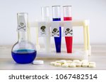 Small photo of poison of Russian origin: Signs of virulence on test tubes of the color of the Russian flag, beside a flask, tablets