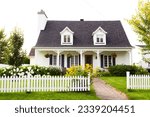 Small photo of Pretty petite ancestral neoclassical white clapboard house with shingled roof and picket fence in the Ste-Foy area, Quebec City, Quebec, Canada