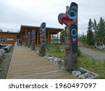 Small photo of Teslin, Yukon, Canada - July 17 2017: Teslin Tlingit Heritage Centre with totems outside of centre