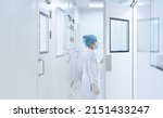 Small photo of Unidentified microbiologist is open the cleanroom door to enter the room in clean area of microbial laboratory in pharmaceutical factory, concept of science, healthcare and safety operation.