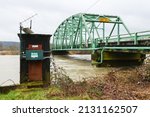 Small photo of Carnation, WA, USA - March 01, 2022; Snoqualmie River flowing past the USGS Stream Gaging Station in Carnation. The river is at 57.97 ft and 39,200 cfs which created the brown river flood water