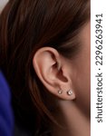 Small photo of piercings on an ear. Conch and helix piercings close up