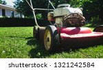 Red Old Lawn Mower On Meadow Of ...