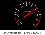 Instrument panel with tachometer and fuel level temperature engine, Close up image of illuminated car dashboard. Red arrow moving