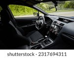 Dark car interior - steering wheel, shift lever and dashboard. Car modern  inside. Side view 