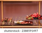 Various light snacks, dishes for holiday. Catering plate on buffet table for party. Beautifully decorated catering banquet table with different food snacks and appetizers. Decoration for a banquet.