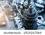 Small photo of Closeup disassembled car automatic transmission gear part on workbench at garage or repair factory station for fix service or maintenance. Vehicle part detail. Complex industrial mechanism background