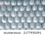 Close-up detail metallic texture pattern matte medieval replica steel chain mail scales plates knight armor. Old ancient iron metal body armour protection. Abstract chainmale dragon skin background
