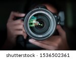 photographer  take pictures Snapshot with camera. man hand holding with camera looking through lens.Concept for photographing articles Professionally