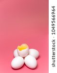 cracked egg with white and yolk ... | Shutterstock . vector #1049566964