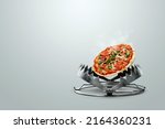 Small photo of Pizza in a bear trap, close-up. The concept of gluttony, obesity, fast food, addiction, malnutrition