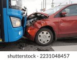 Small photo of Frontal collision of a car and a bus. Head-on collision between bus and car. Car accident. Traffic accident.
