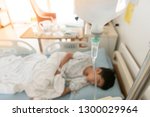 Small photo of Little boy get sick from influenza need to be admitted to hospital with saline intravenous (iv) in-line hand pressure