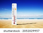 Hot summer day. Celsius scale thermometer in the sand. Ambient temperature plus 7 degrees 