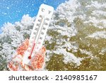 White celsius and fahrenheit scale thermometer in hand. Ambient temperature minus 8 degrees celsius