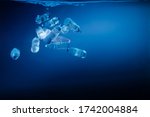 Plastic bottles sinking in to the ocean. Enviromental polution concept. World ocaens day