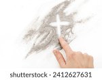 Small photo of Cross made of ashes, Ash Wednesday, Lent season abstract background