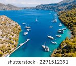 Small photo of Aerial drone photo of Binlik Bay, located in the midst of Gocek and Dalaman, Fethiye. Daily tour boats and private yachts anchor to have serenity and enjoy the secluded bay.