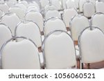 White Chairs Arranged In A...