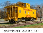 Small photo of Hazen, USA – November 28, 2022 - A bright yellow vintage Union Pacific Railroad caboose in Hazen, Arkansas