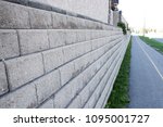 Small photo of Retaining wall next to pavement on city Street