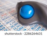 Small photo of A wireless trackball mouse on a spreadsheet