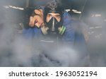 Small photo of Technician wears an NH3 ammonia protective mask to help an unconscious colleague suffocate urgently due to the violent ammonia gas leaking in the work area in the frozen food industry :Selective focus