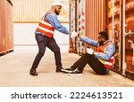 African American engineer and foreman join hands to pull the hand of a black male worker who sits in despair in a container yard longing for spirit positive of hope and standing up for success.