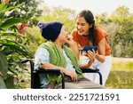 Small photo of Asian family, grateful daughter takes care of mother who is sick and disabled with paralysis, feeds her food to restore her body and keep her healthy : Elderly insurance health care concept