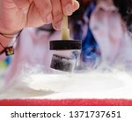 Small photo of Demonstration of Quantum Magnetic Levitation and Suspension Effect. A splash of liquid nitrogen cools a ceramic superconductor forcing it to float in air below a magnet