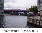 Small photo of London, UK - July 17 2016: a DLR (Docklands Light Railway) train crossing the bridge over North Dock in Canary Wharf, Tower Hamlets