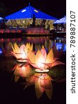 Small photo of Vesak lotus lanterns floating on lake water with light reflect and seema malaka public temple in buddhism religion night.