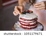 Small photo of A girl making a homemade cake with an easy recipe, sprinkling sugar powder on top. Sitting sugar, strewed colander