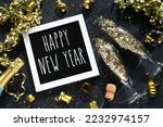 Happy New Year - flat lay champagne glasses bottle gold glitter confetti golden streamers