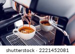 Small photo of Coffee extraction from the coffee machine with a portafilter pouring coffee into a cup, Espresso pouring from coffee machine