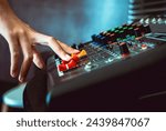 Small photo of Close-up of sound engineer hands adjusting control sound mixer in recording, broadcasting studio,Sound mixer. Professional audio mixing console, buttons, faders and sliders. sound check.