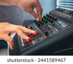 Small photo of Sound engineer hands adjusting control sound mixer in recording, broadcasting studio,Sound mixer. Professional audio mixing console, buttons, faders and sliders. sound check.
