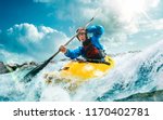Whitewater kayaking, extreme kayaking. A guy in a kayak sails on a mountain river