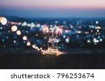 Sparklers in a glass jar that bokeh cities background.